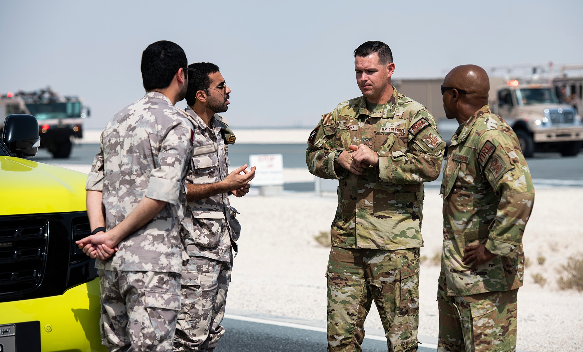 U.S. Air Force fire fighters talk to Qatari Emiri Air Force members.
