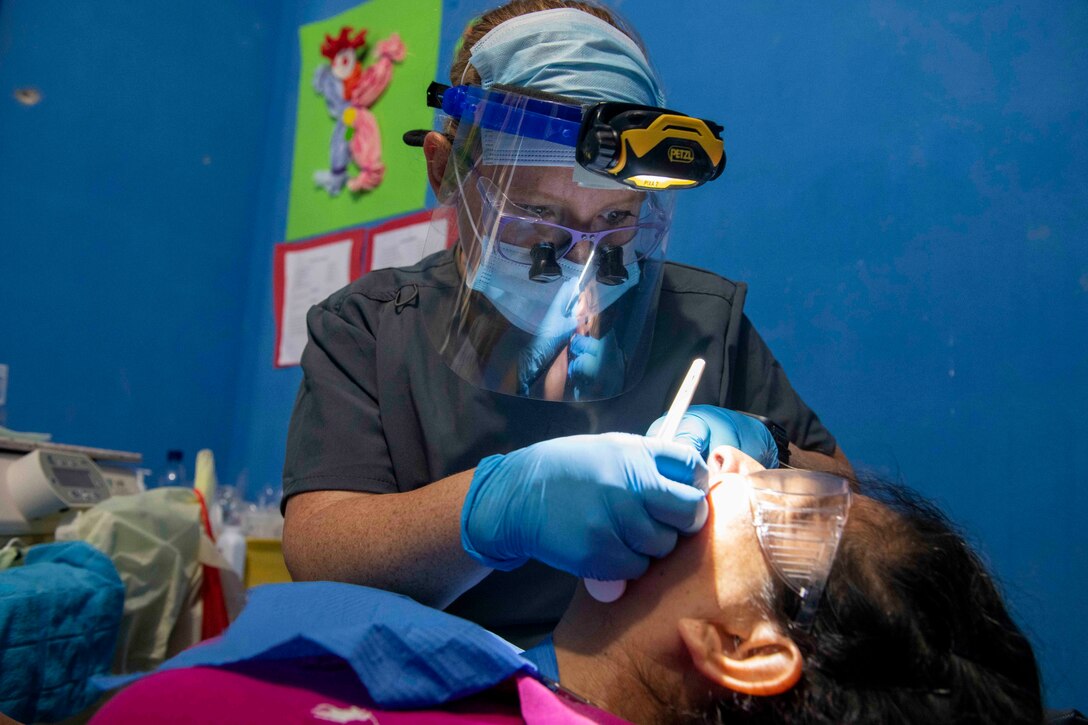 Image of an Airman providing dental care.