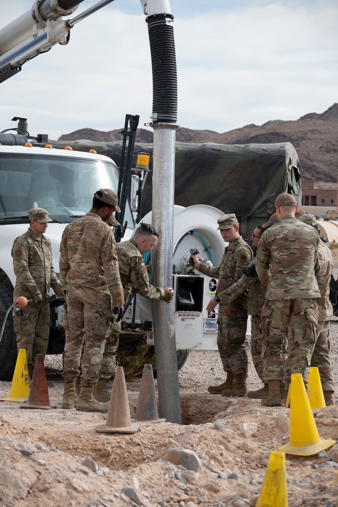 Airmen gathers around a whole