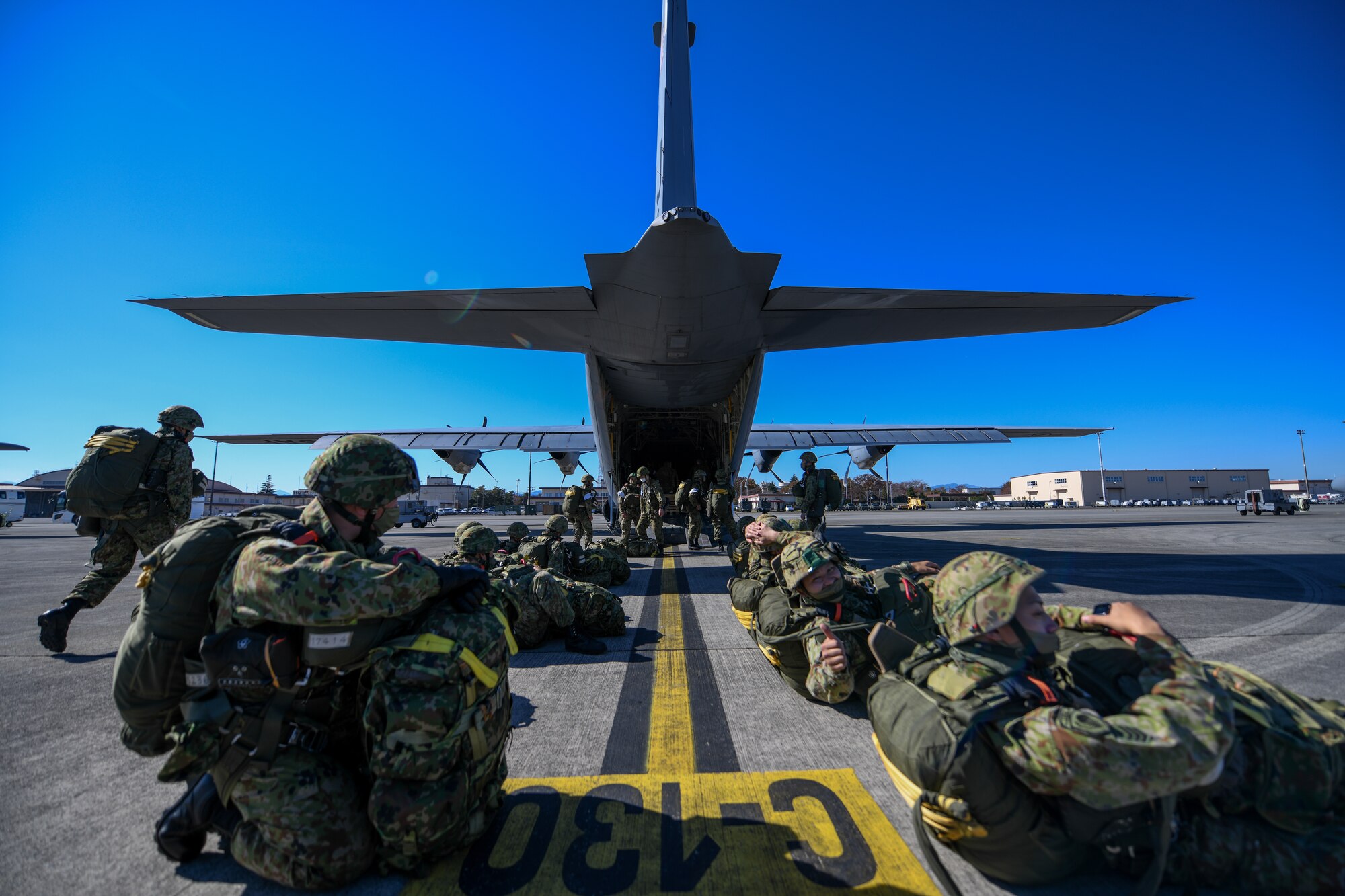 Japan Ground Self-Defense Force soldiers line up outside a C-130J