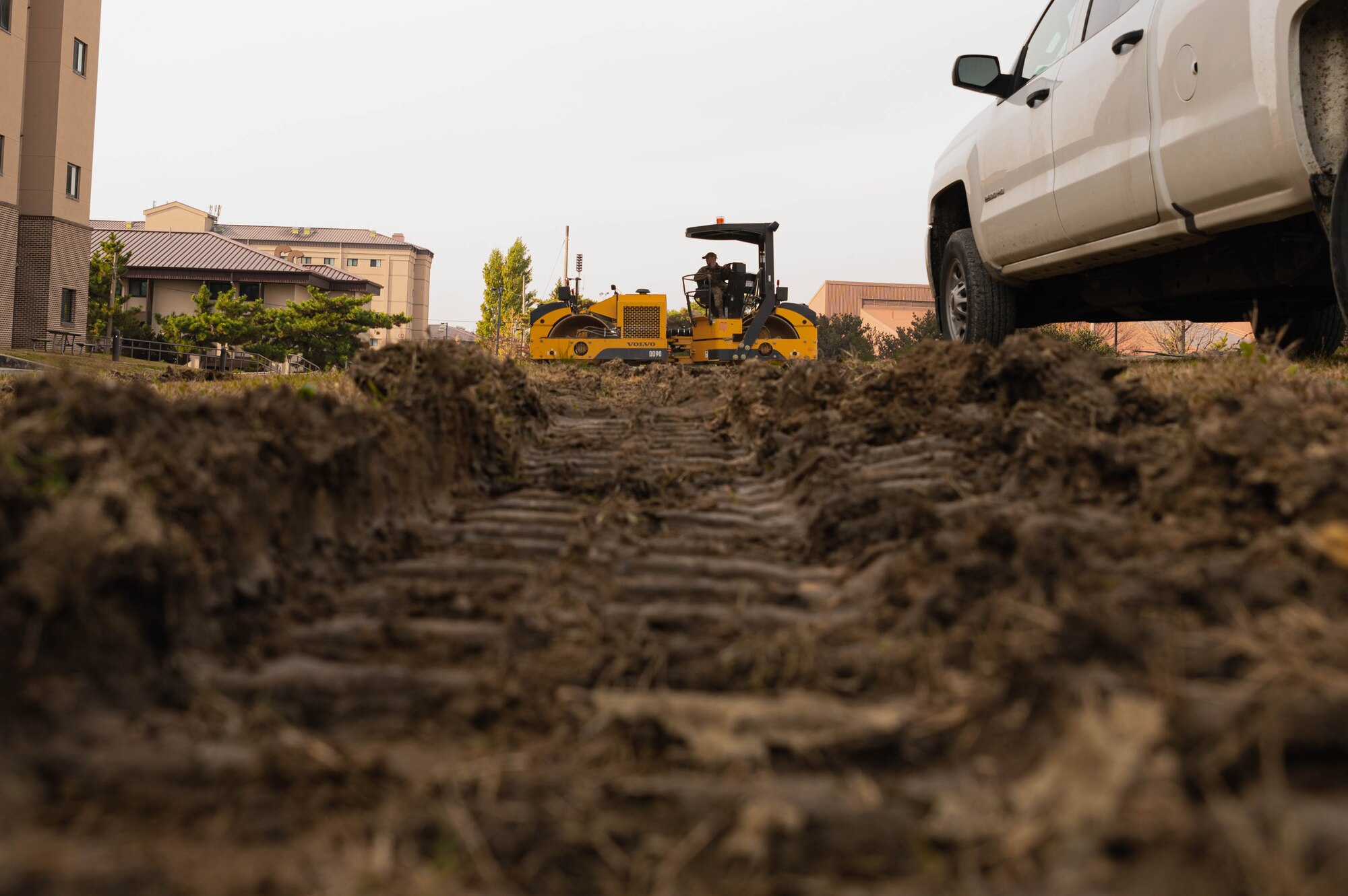 Senior Airman Christopher Oberhart, 51st Civil Engineering Squadron pavements and equipment shop Airman, levels gravel for a parking lot at Osan