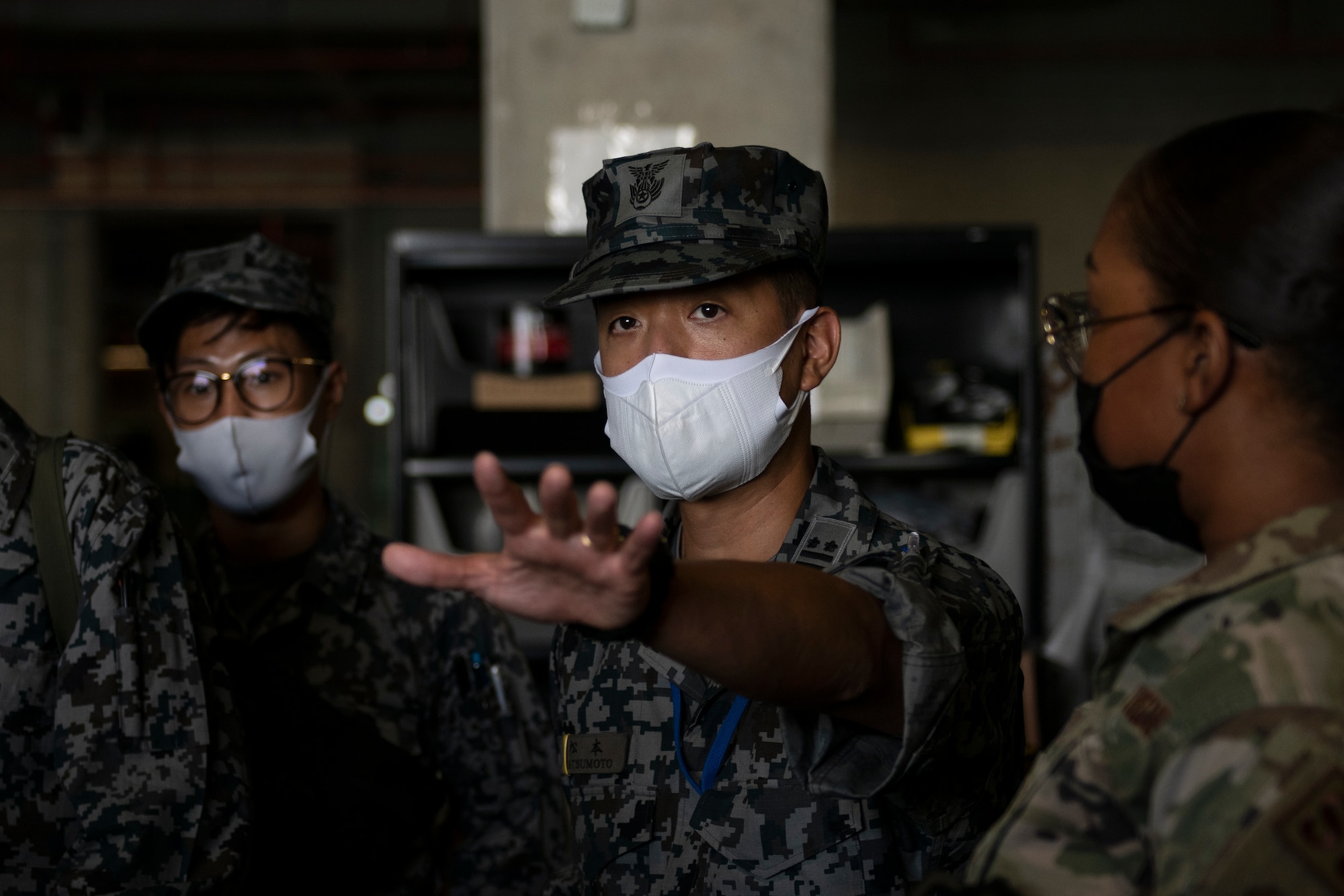 Japan Air Self-Defense Force Lt. Col. Sunao Matsumoto, 9th Air Wing base supply commander, inquires about the inventory system during a tour of the 18th Logistics Readiness Squadron mobility processing building at Kadena Air Base, Japan, Nov. 10, 2021. Bilateral training and exchanges between the U.S. and Japan increases mutual understanding and strengthens interoperability among military forces. (U.S. Air Force photo by Senior Airman Jessi Monte)