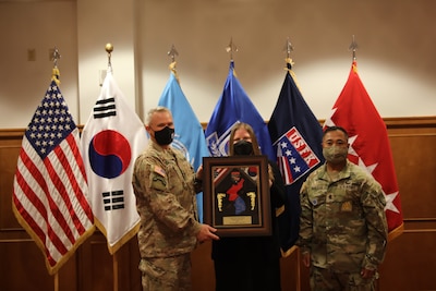 Gen. Paul J. LaCamera, UNC/CFC/USFK commander, and USFK Command Sgt. Maj. Walter A. Tagalicud, stand with Ms. Jacqueline Leeker, the U.S. Manager of the Year recipient for the 2021 USFK Civilian Employee of the Year Award Ceremony at Riverbend Golf Course on Nov. 17, 2021. (U.S. Army photos by PFC Kim, Sang-Heon)