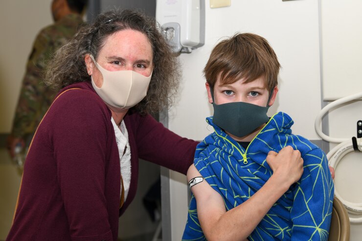 Family poses after receiving the pediatric version of Pfizer’s COVID-19 vaccine