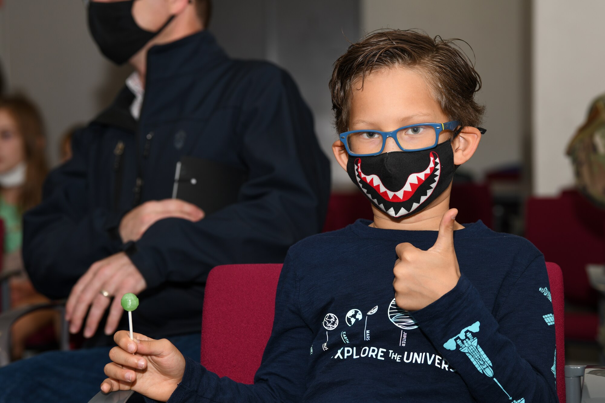 Boy poses after receiving the pediatric version of Pfizer’s COVID-19 vaccine