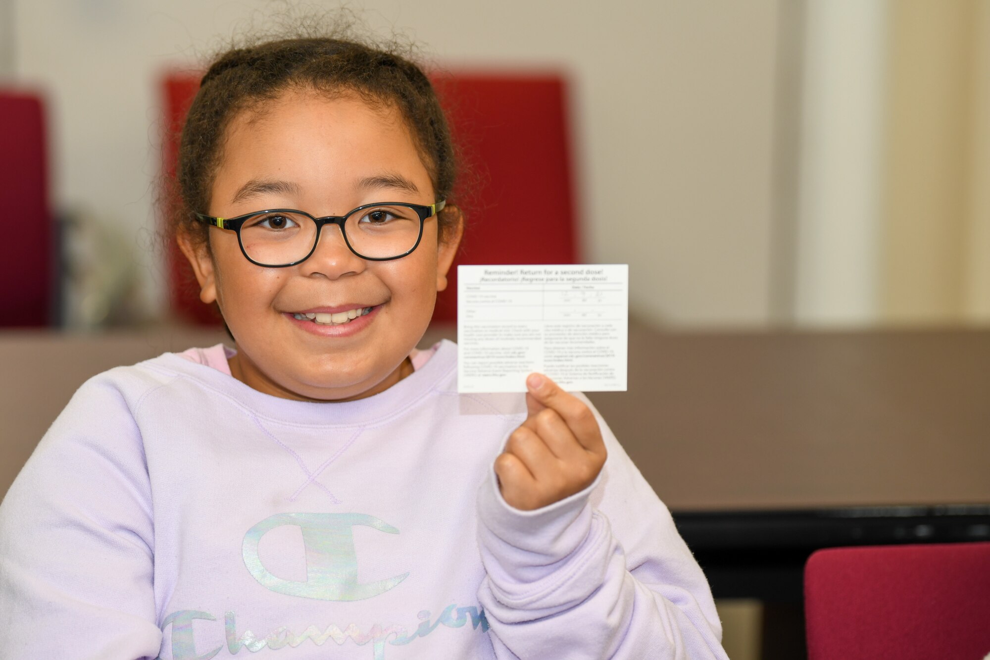 Girl poses after receiving the pediatric version of Pfizer’s COVID-19 vaccine