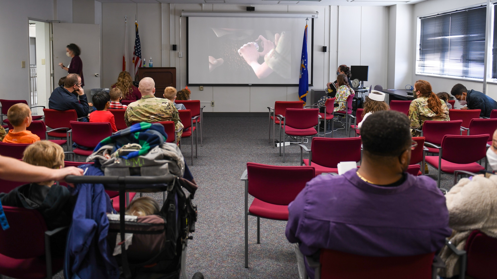 Yokota parents sit in a waiting area after their children received a COVID-19 vaccine