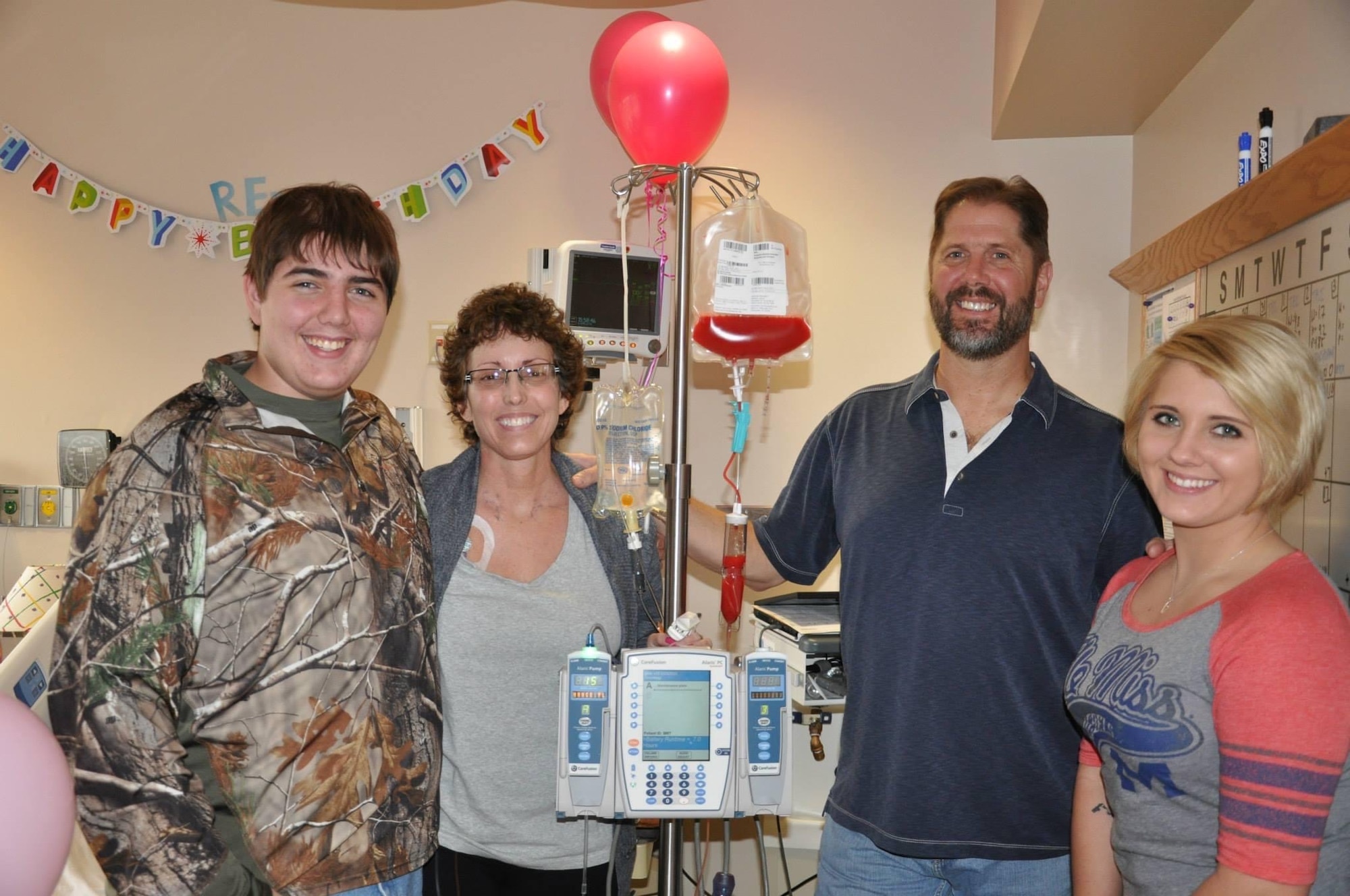 (From right to left) Staff Sgt. Brenna Reineck-Watson, then Brenna Reineck; Greg Reineck; Dawn Reineck and Hunter Reineck pose for a photo April 3, 2015, in the Froedtert Hospital Bone Marrow Transplant Unit in Milwaukee, Wisconsin. Dawn received a STEM cell transplant from an anonymous donor as treatment for Acute Lymphocytic Leukemia. (Courtesy photo)