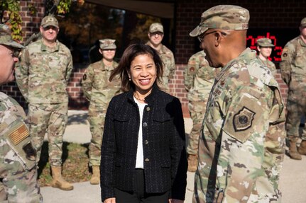 Mrs. Sharene Brown (center), spouse of Air Force Chief of Staff Gen. CQ Brown, Jr. (right), speaks with Gen. Brown and U.S. Air Force Col. Tyler Shaff, 316th Wing and installation commander, (left), outside of the Freedom Inn Dining Facility at Joint Base Andrews, Md., Nov. 17, 2021. Mrs. Brown attended a working lunch with the 316th Wing leadership spouses as a part of her visit while Gen. Brown met with Airmen across the installation. (U.S. Air Force photo by Airman Matthew-John Braman)