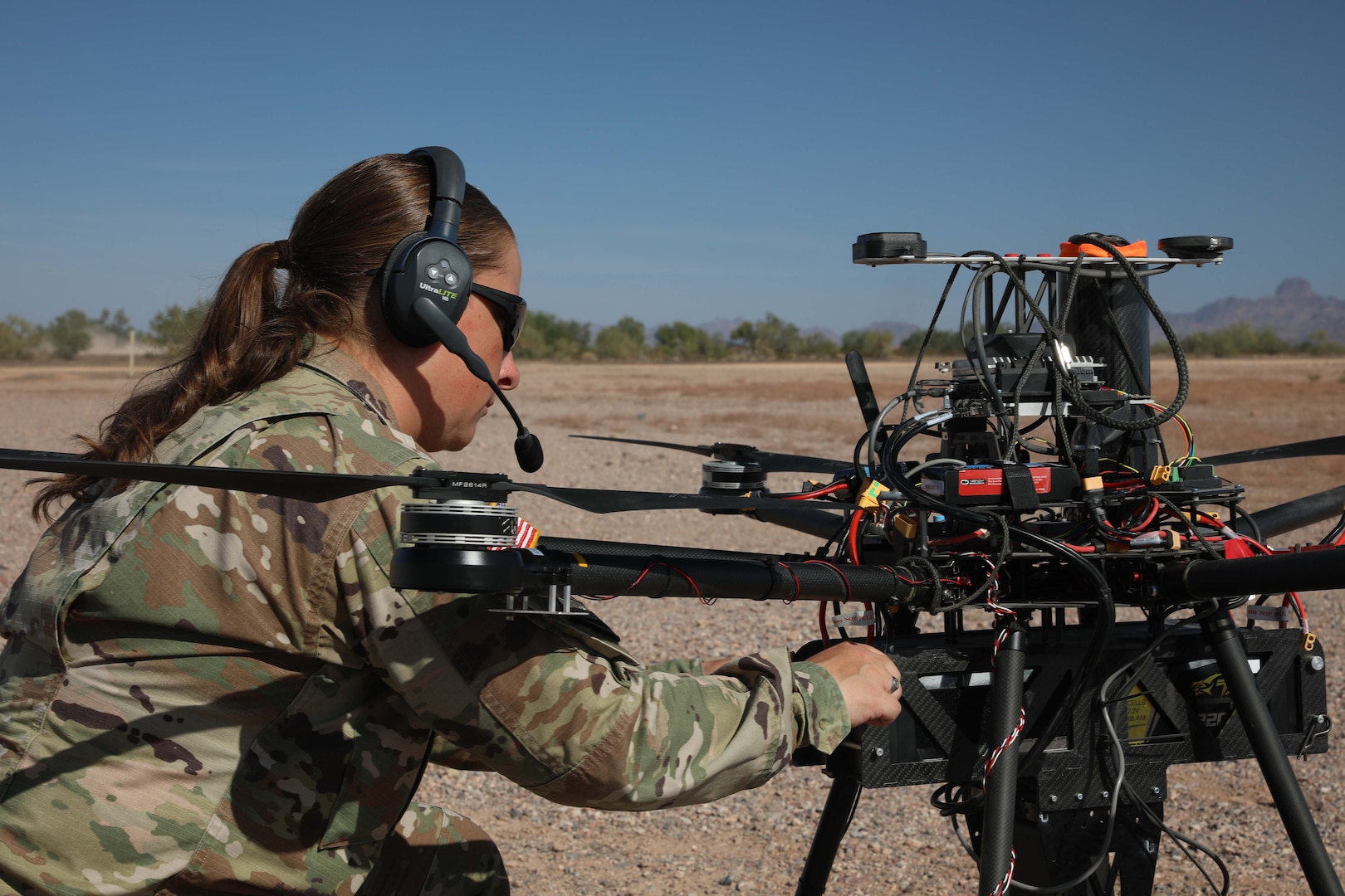 A soldier works on a drone.