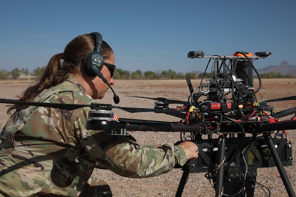 A soldier works on a drone.