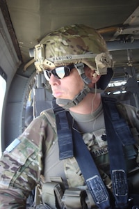 Lt. Col. Thomas Mancino, commander 45th Brigade Special Troops Battalion, 45th Infantry Brigade Combat Team, rides in a UH-60 Black Hawk helicopter while deployed to Afghanistan in 2011.