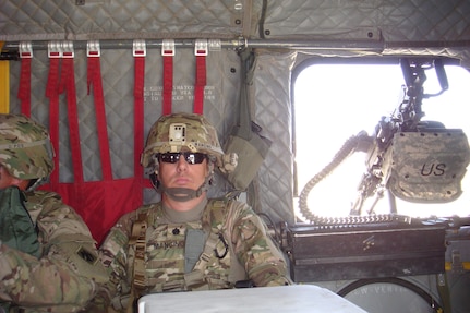 Lt. Col. Thomas Mancino, commander 45th Brigade Special Troops Battalion, 45th Infantry Brigade Combat Team, rides in a CH-47 Chinook helicopter while deployed to Afghanistan in 2011.