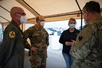 Representatives from state and federal agencies, such as the Oklahoma Army and Air National Guard, Centers for Disease Control and Prevention, the Oklahoma State Department of Health, Oklahoma State University laboratories, and the Federal Emergency Management Agency, speak outside the Seaboard Foods pork processing plant in Guymon, Oklahoma during a visit to the city, May 15, 2020. As of May 19, 2020, Guymon had 650 confirmed cases of COVID-19, making it second in the total number of cases in Oklahoma. Oklahoma City, which has the highest number of COVID-19 cases, has the largest population of any city in Oklahoma, Guymon is 40th. Most the cases were traced back to pork processing plant, which is classified as an essential business and produces roughly 4.2 million pounds of pork products per day while employing about 2,700 employees from the county and surrounding states. (Oklahoma Air National Guard photo by Tech. Sgt. Kasey M. Phipps)