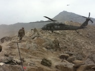 Lt. Col. Thomas H. Mancino and Soldiers assigned to the 45th Infantry Brigade Combat Team load into a UH-60 Black Hawk Helicopter during operations in Afghanistan while deployed there in 2011. Mancino served as the commander of the 45th Brigade Special Troops Battalion, 45th Infantry Brigade Combat Team.