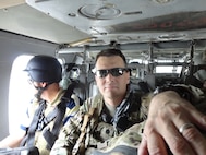 Lt. Col. Thomas H. Mancino, rides is a helicopter while deployed to Afghanistan as the commander of the 45th Brigade Special Troops Battalion, 45th Infantry Brigade Combat Team in 2011.