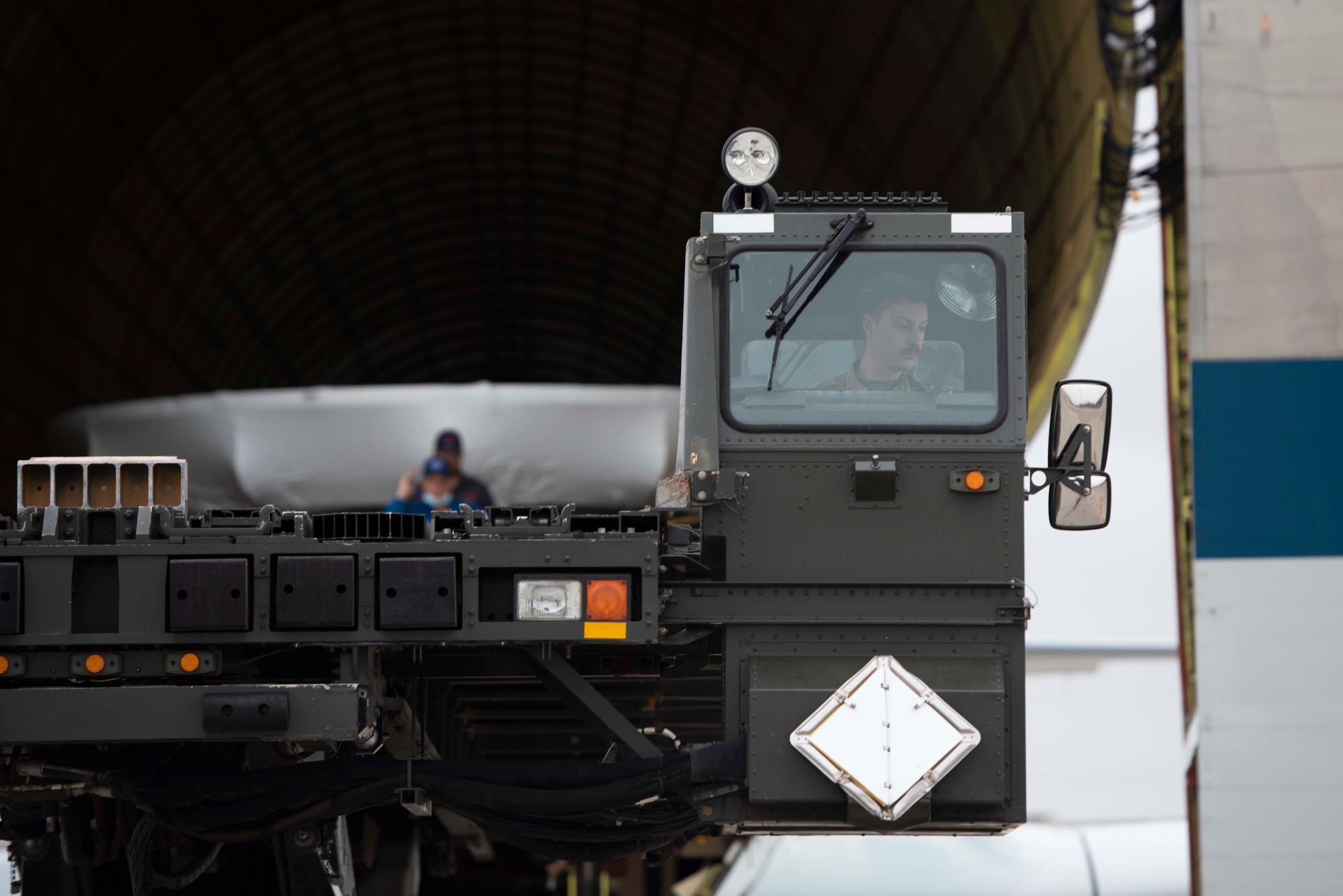 A photo of an Airman driving a vehicle