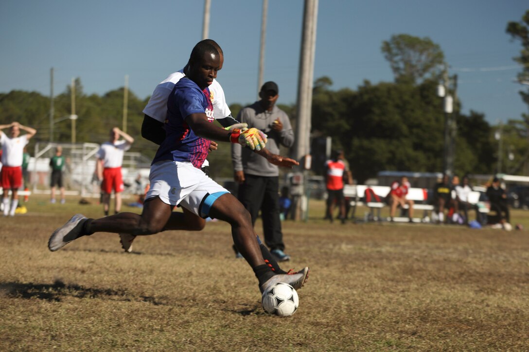 A soldier plays soccer.