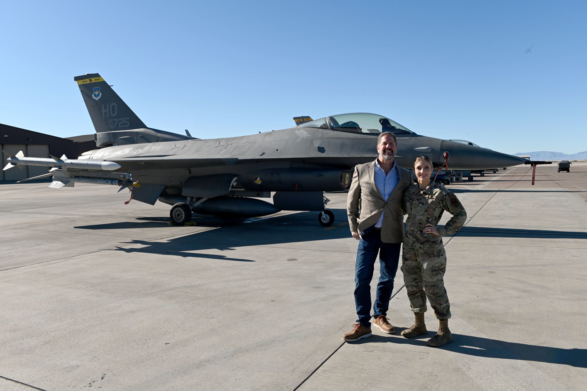 (From right to left) Staff Sgt. Brenna Reineck-Watson, 8th Fighter Squadron squadron aviation resource management noncommissioned officer in charge, poses with her father Greg Reineck in front of a F-16 Viper Nov. 12, 2021 on Holloman Air Force Base, New Mexico. Reineck-Watson's mother received a STEM cell transplant in 2015 following a diagnosis of Acute Lymphocytic Leukemia. Reineck-Watson is an active advocate for DoD-affiliated persons to register for the Salute to Life program, and for non-DoD-affiliated persons to register for the Be the Match program. (U.S. Air Force photo by Staff Sgt. Christopher S. Sparks)