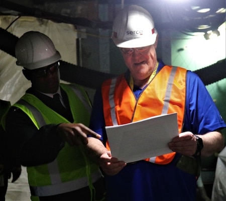 Cmdr. Brian Anthony, commanding officer, USS Winston S. Churchill, reviews some of the plans for the ship’s future layout of the Combat Information Center, with the Hon. Rupert Soames, OBE.