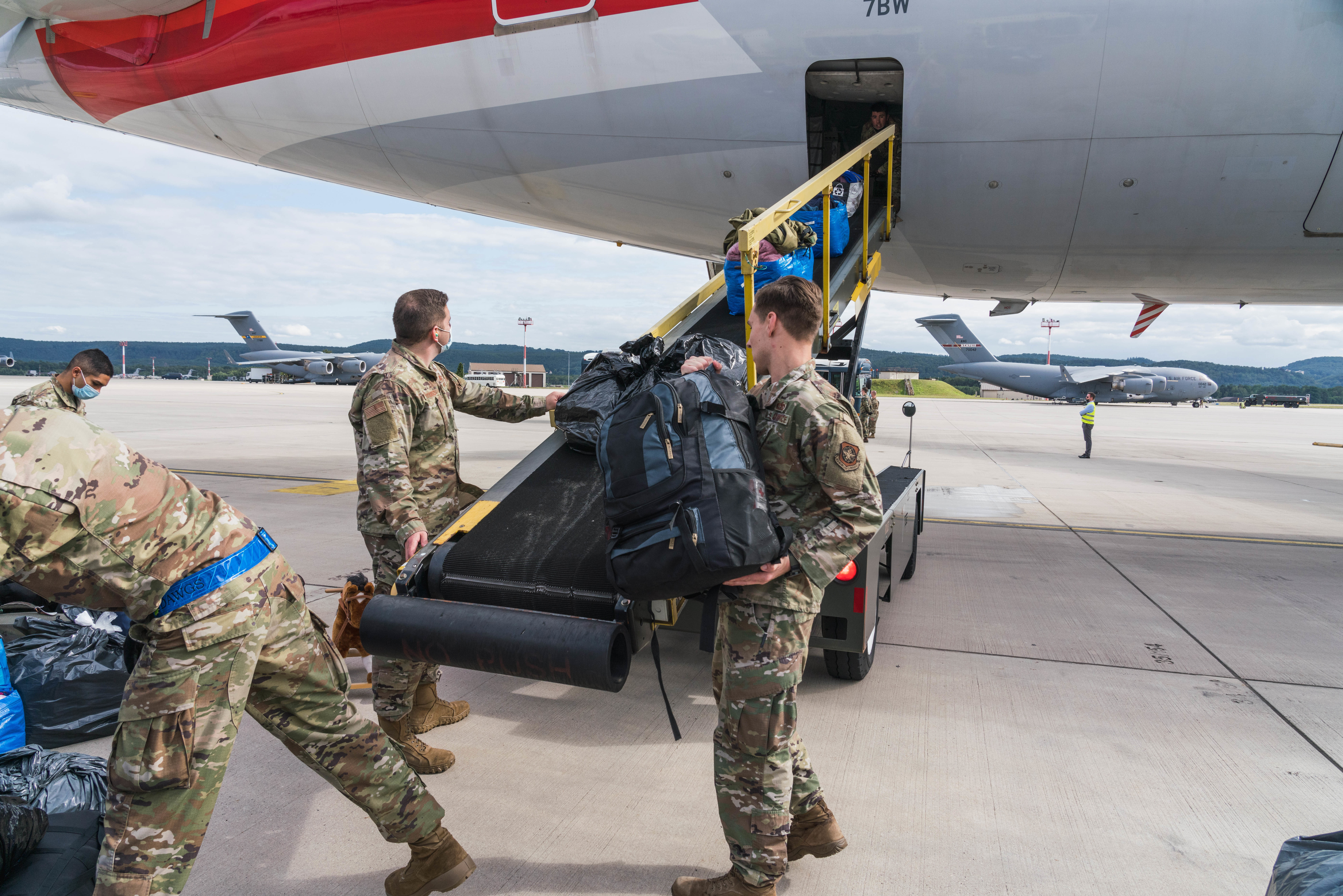 U.S. Air Force Airmen assigned to the 721st Aerial Port Squadron load luggage onto an American Airlines aircraft during Operation Allies Refuge at Ramstein Air Base, Germany, Aug. 27, 2021. Civil Reserve Air Fleet Aircraft are being used for the onward movement of evacuees from temporary safe havens and interim staging bases. (U.S. Air Force photo by Tech. Sgt. Donald Barnec)