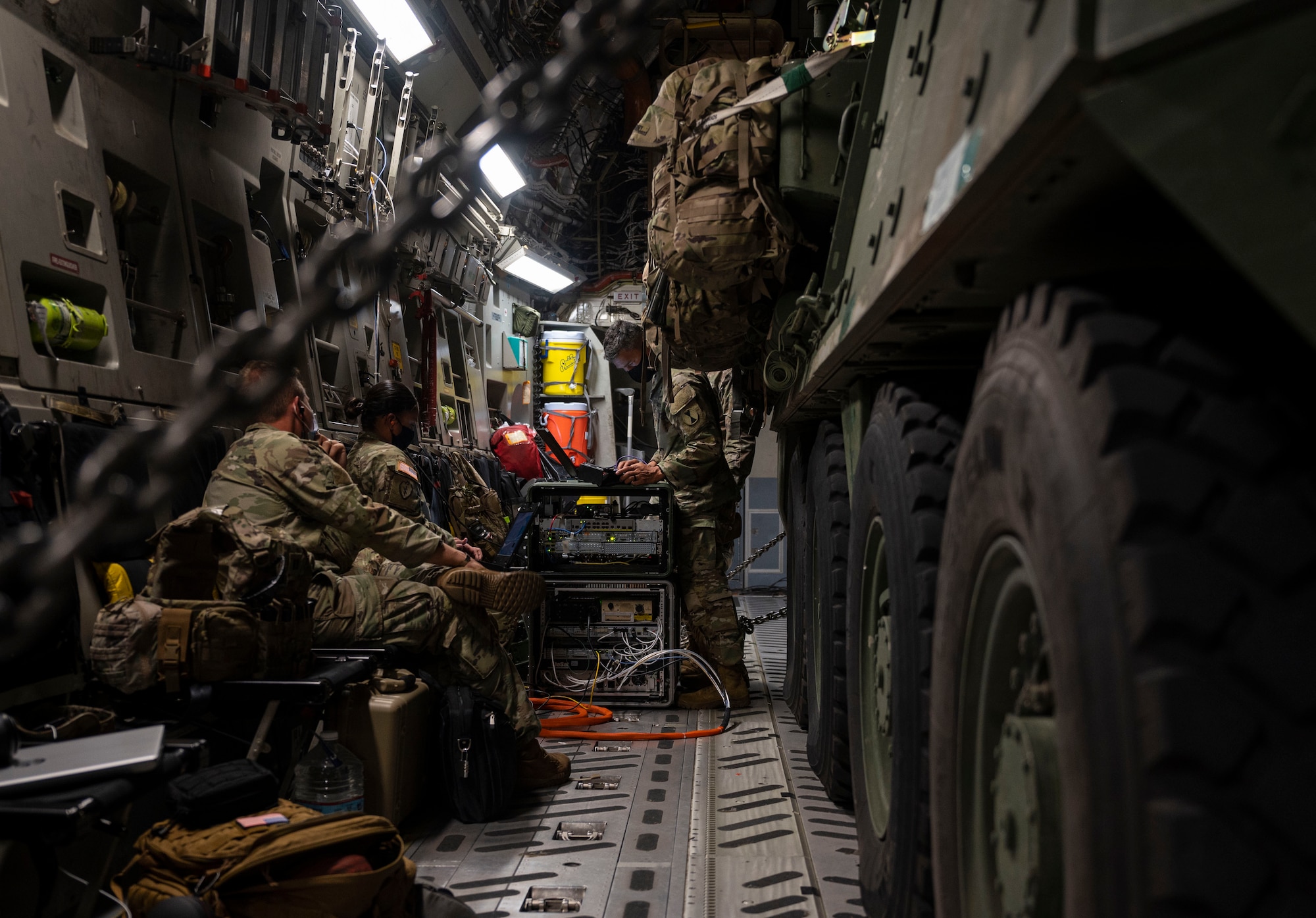 U.S. Soldiers with America’s I Corps set up and test a new, early entry command post concept aboard a C-17 Globemaster III while flying in the U.S. Indo-Pacific Command area of responsibility during Exercise Rainier War 21B Nov. 9, 2021. I Corps deployment and redeployment efforts from Andersen Air Force Base, Guam, included ensuring uninterrupted communication capabilities, even while in flight, aboard a C-17 Globemaster III. Rainier War 21B exercised and evaluated the 62nd Airlift Wing’s ability to employ the force and their ability to perform during wartime and contingency taskings in a high-intensity, wartime contested, degraded and operationally limited environment while supporting the contingency operations against a near-peer adversary in the U.S. Indo-Pacific Command area of responsibility. (U.S. Air Force photo by Staff Sgt. Rachel Williams)