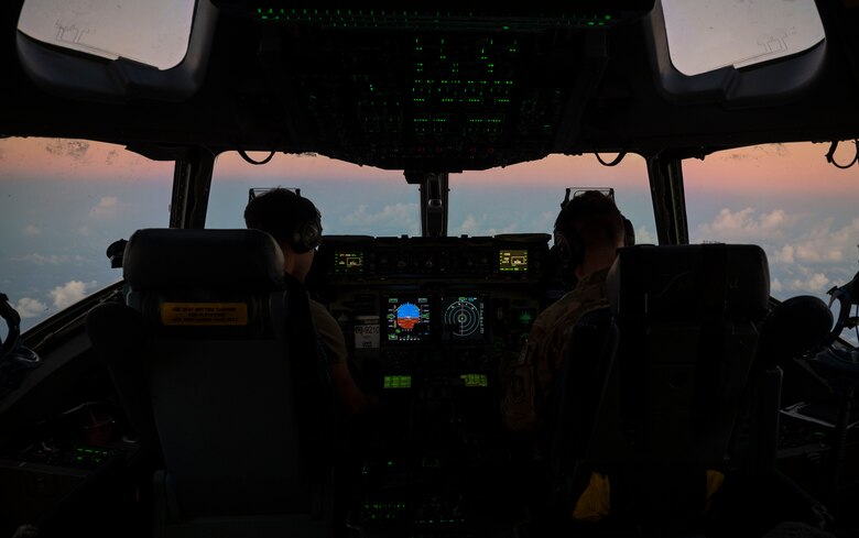 U.S. Air Force 1st Lt. Christopher Ferrario, left, a co-pilot with the 7th Airlift Squadron, and U.S. Air Force Maj. John Greenway, a pilot with the 7th AS, fly a C-17 Globemaster III over the Pacific Ocean to Joint Base Pearl Harbor-Hickam, Hawaii, during Exercise Rainer War 21B Nov. 9, 2021,. Rainier War 21B exercised and evaluated the 62nd Airlift Wing’s ability to employ the force and their ability to perform during wartime and contingency taskings in a high-intensity, wartime contested, degraded and operationally limited environment while supporting the contingency operations against a near-peer adversary in the U.S. Indo-Pacific Command area of responsibility. (U.S. Air Force photo by Staff Sgt. Rachel Williams)