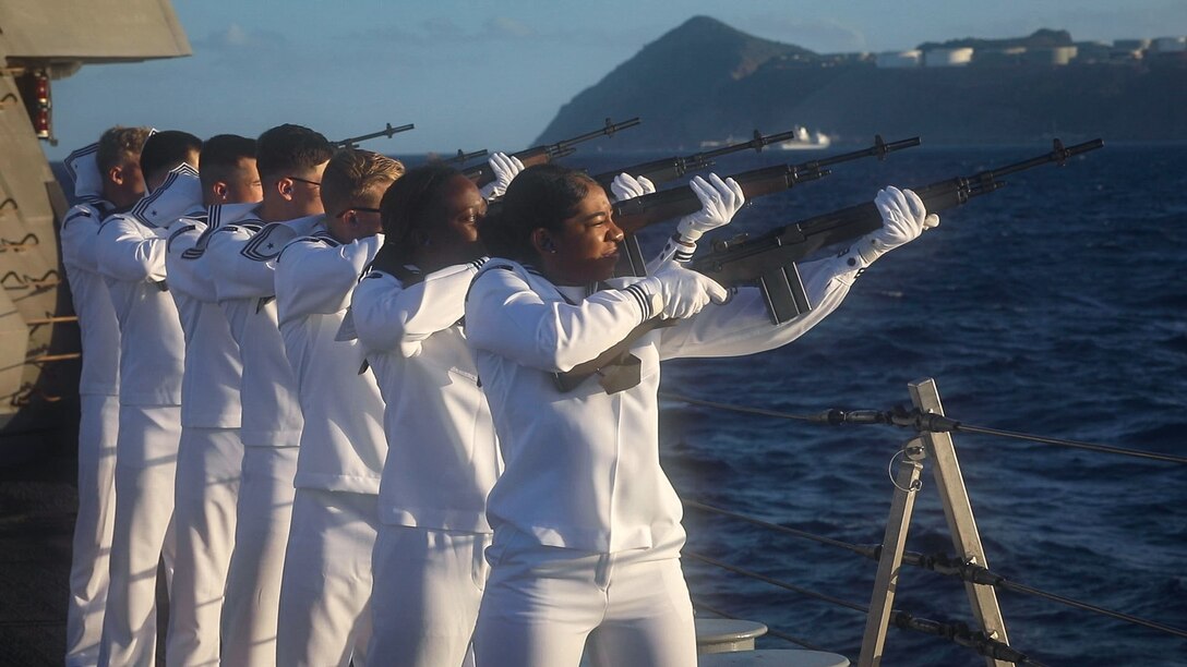 SINT EUSTATIUS, Netherlands - (Nov. 16, 2021) -- Members of the rifle team on the Freedom-variant littoral combat ship USS Sioux City (LCS 11) conduct a 21-gun salute in honor of Statia Day, Nov. 16, 2021. Statia Day is a national holiday celebrated on the Caribbean island of Sint Eustatius. It celebrates the “first salute” when Sint Eustatius, locally known as Statia, became the first country to recognize the United States as a nation 245 years ago when after the U.S. declared independence, a Continental Navy ship fired a gun salute upon entering the harbor, and the island, by order of the Dutch governor, returned the salute. Sioux City is deployed to the U.S. 4th Fleet area of operations to support Joint Interagency Task Force South’s mission, which includes counter-illicit drug trafficking missions in the Caribbean and Eastern Pacific. (U.S. Navy photo by Mass Communication Specialist 3rd Class Juel Foster/Released)