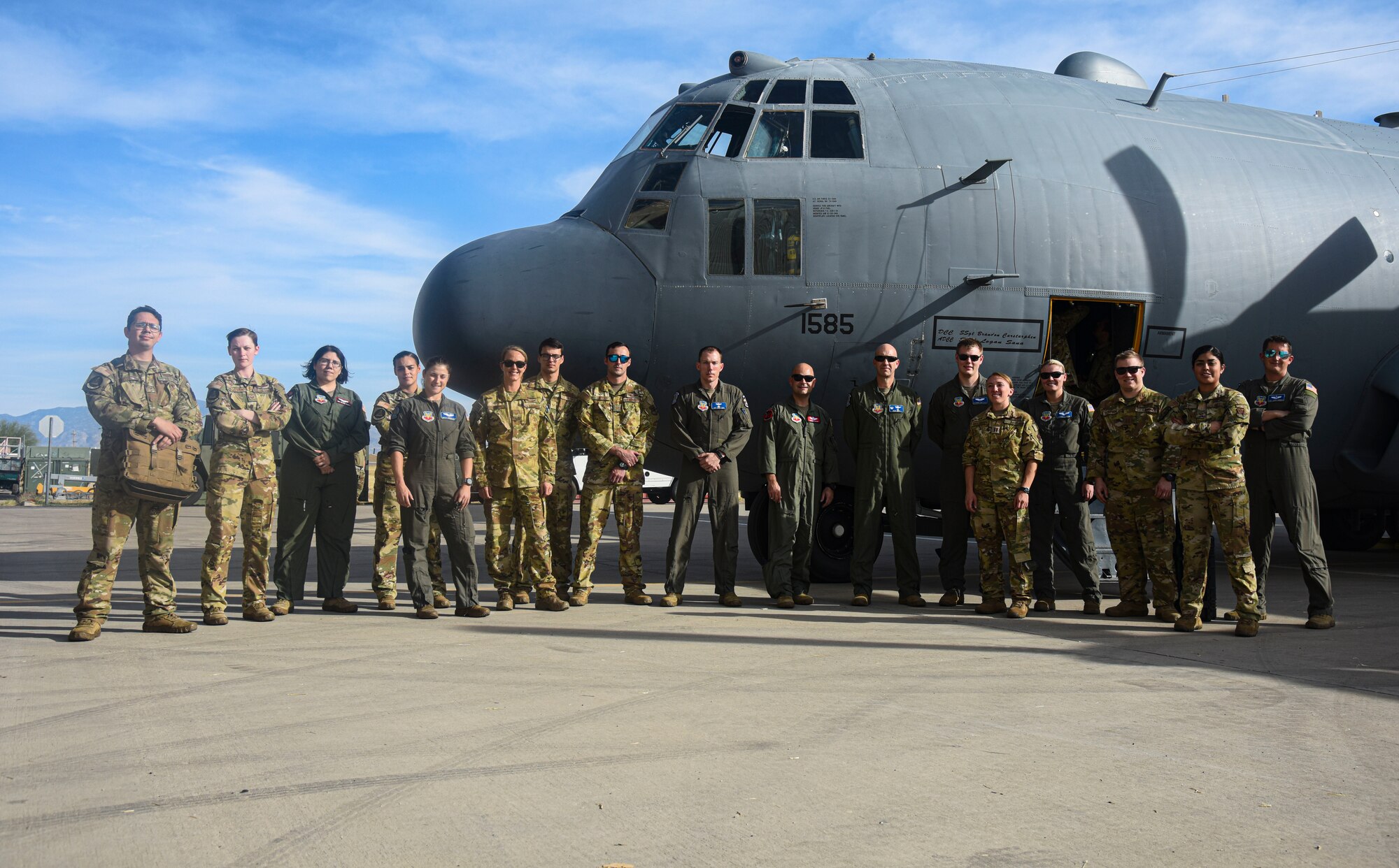 Pictured above is a group of people posing in front of an aircraft.