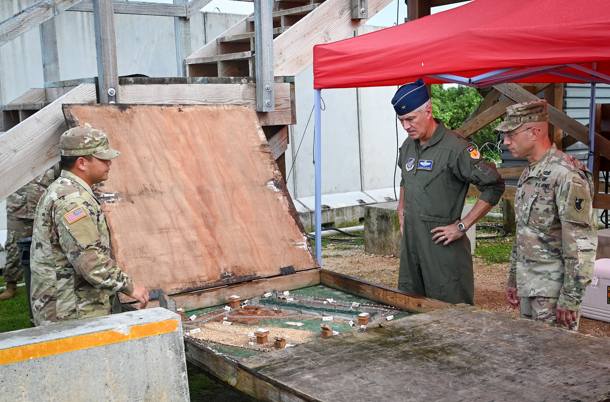 U.S. Air Force Brig. Gen. Jeremy Sloane, commander of the 36th Wing, and U.S. Army Col. Matthew Dalton, commander of the 38th Air Defense Artillery Brigade, receive a brief during Operation Iron Island at Site Armadillo, Nov. 17, 2021.