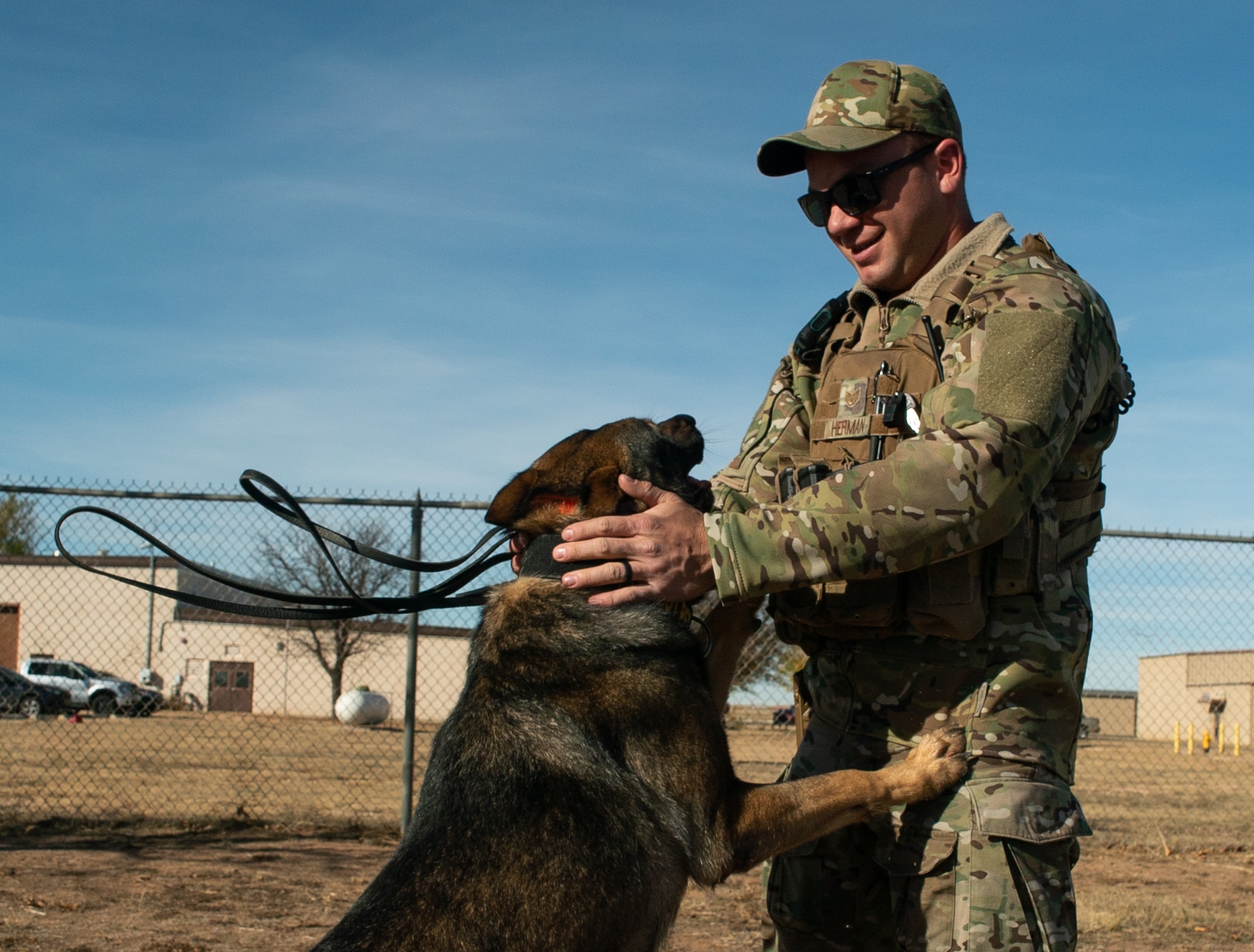 Military Working Dog Fulda W378, 27th Special Operations Security Forces Squadron K-9, jumps on his handler and adopter U.S. Air Force Staff Sgt. Michael Herman, 27 SOSFS K-9 handler, at the K-9 training grounds on Cannon AFB, N.M., Nov. 15, 2021. The bond between MWDs and their handlers is crucial to the success of their mission, as the understanding between both individuals keeps them alert and engaged while on the job. (U.S. Air Force photo by Senior Airman Christopher Storer)