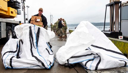 NAVAL MAGAZINE INDIAN ISLAND, Wa. (211104-N-QL961-1009) Active duty and reserve officers, and senior enlisted Sailors from Commander Submarine Group Nine, Commander Submarine Squadron 17, and Submarine Readiness Squadron 33 pack around 2,000 pounds of food and supplies to be sent to a submarine participating in Global Thunder 22 (GT 22). GT 22 is an annual training exercise designed to train and assess joint operational readiness across all of U.S. Strategic Command’s mission areas, with a specific focus on nuclear readiness, deterrence, defeat a military attack on the U.S. and employ forces as directed by the president. (U.S. Navy photo by Mass Communication Specialist 1st Class Phillip Pavlovich/Released)