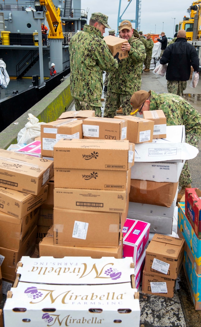 NAVAL MAGAZINE INDIAN ISLAND, Wa. (211104-N-QL961-1038) Active duty and reserve officers, and senior enlisted Sailors from Commander Submarine Group Nine, Commander Submarine Squadron 17, and Submarine Readiness Squadron 33 pack around 2,000 pounds of food and supplies to be sent to a submarine participating in Global Thunder 22 (GT 22). GT 22 is an annual training exercise designed to train and assess joint operational readiness across all of U.S. Strategic Command’s mission areas, with a specific focus on nuclear readiness, deterrence, defeat a military attack on the U.S. and employ forces as directed by the president. (U.S. Navy photo by Mass Communication Specialist 1st Class Phillip Pavlovich/Released)