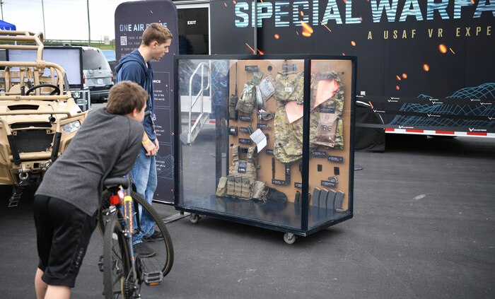 Passersby examine a display case outside of Charlotte Motor Speedway in Conway, N.C., which featured tactical equipment similar to what Special Warfare Airmen might use. The display is part of the Air Force Recruiting Service’s Activate: Special Warfare mobile exhibit and gives guests a four-dimensional Air Force Special Warfare experience as depicted in an online Air Force commercial.