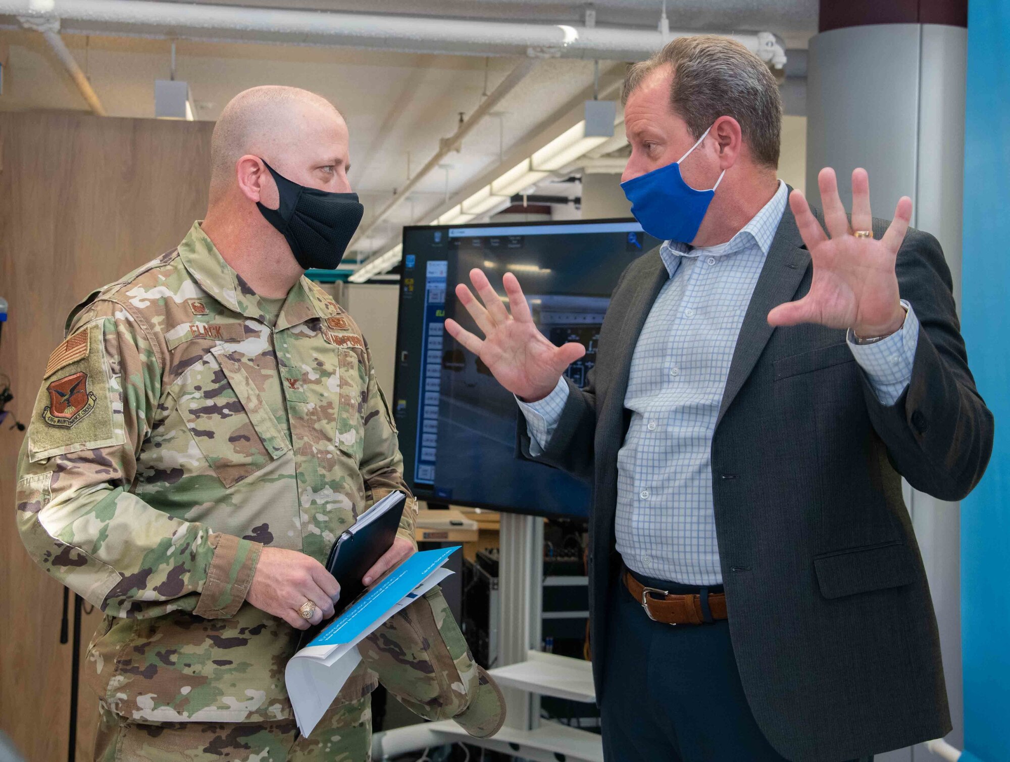 Scott Belanger, right, Boeing Global Services next generation product support specialist, explains the virtual maintenance and aircrew trainer to Col. Bary Flack, 436th Maintenance Group commander, during a visit to Dover Air Force Base, Delaware, Nov. 15, 2021. The VMAT is a virtual reality simulation that provides hands-on training to Airmen. (U.S. Air Force photo by Tech. Sgt. Nicole Leidholm)