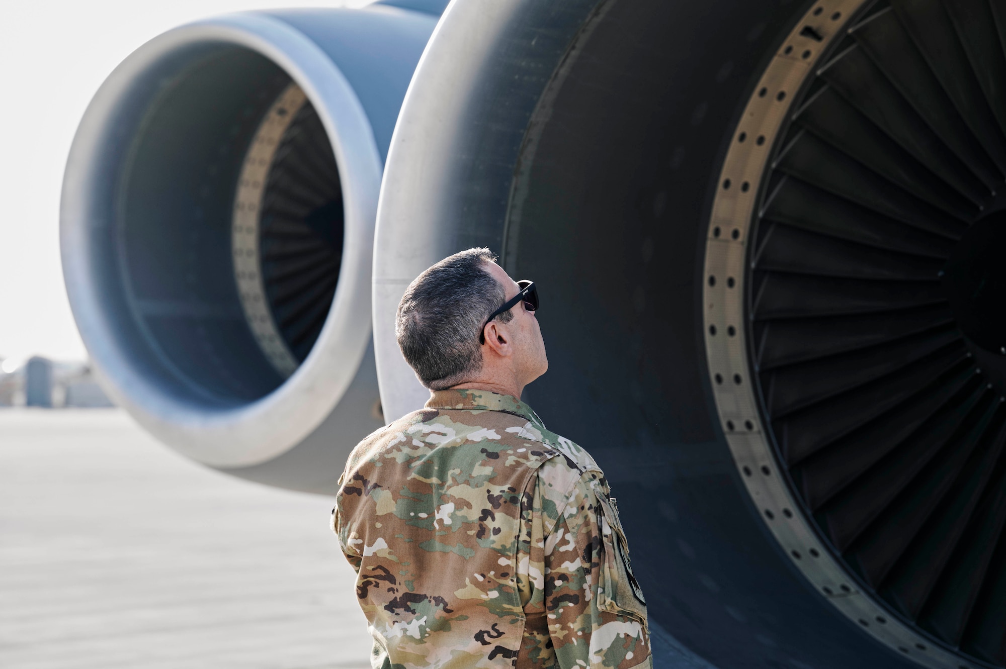 Photo of a U.S. Air Force KC-135 Stratotanker instructor pilot performing pre-flight checks on the aircraft engine.