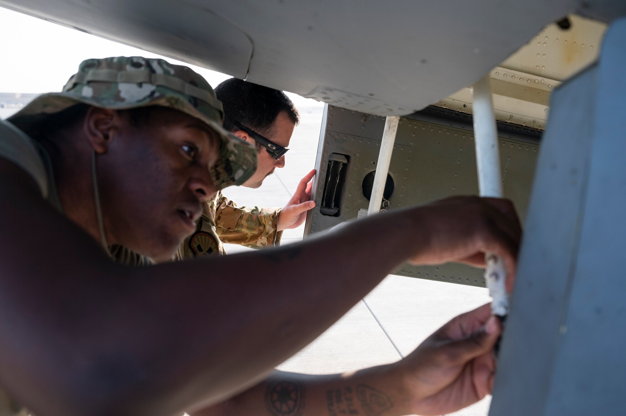 A U.S. Air Force KC-135 Stratotanker maintainer works performs pre-flight checks on the aircraft