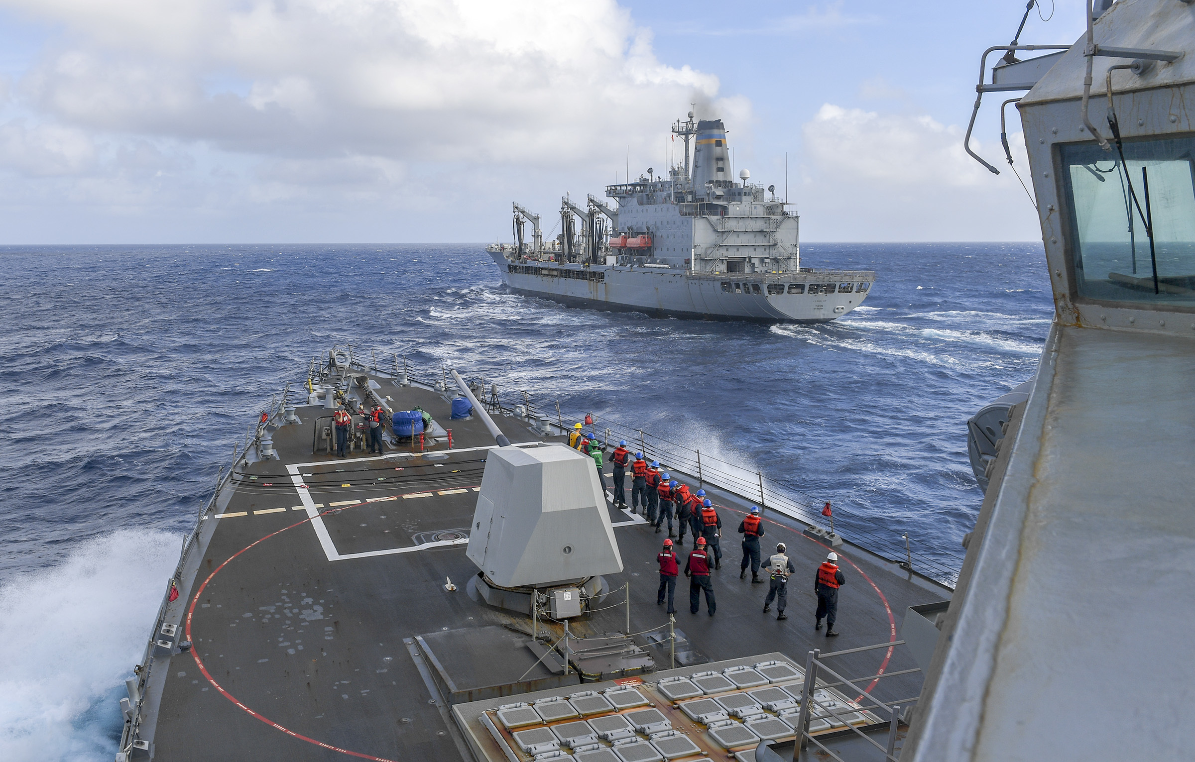 Sailors aboard the Arleigh Burke-class guided-missile destroyer USS Chafee (DDG 90) prepare for a replenishment-at-sea with the Henry J. Kaiser-class fleet replenishment oiler USNS Yukon (T-AO 202), Nov. 17.