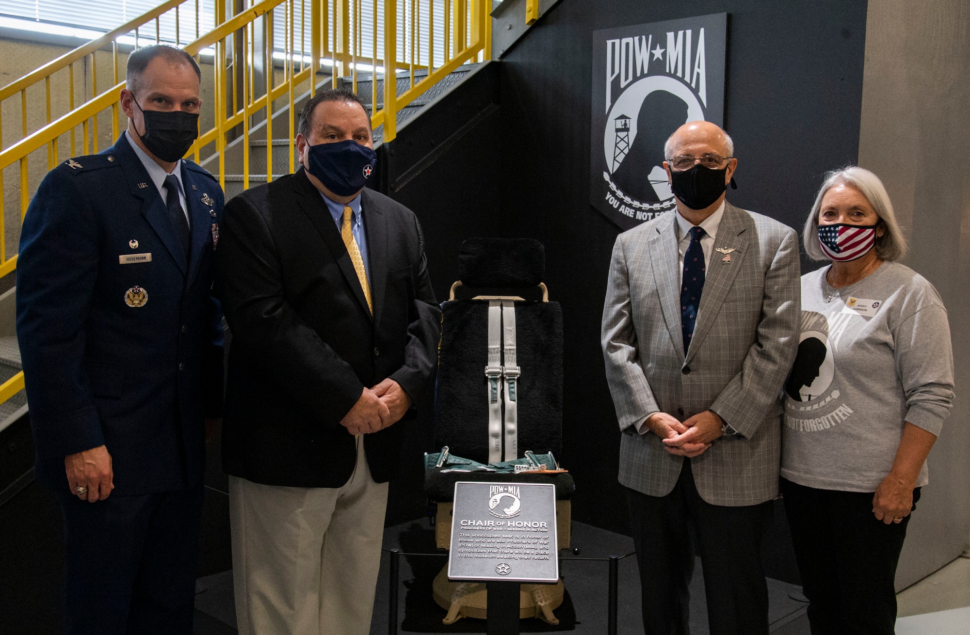 From left, Col. Matt Husemann, 436th Airlift Wing commander; John Taylor, Air Mobility Command Museum director;  Ralph Galati, former prisoner of war; and Rosely Robinson, director of A Hero’s Welcome Delaware, stand by the Chair of Honor display at the Air Mobility Command Museum on Dover Air Force Base, Delaware, Nov. 11, 2021. (U.S. Air Force photo by Roland Balik)