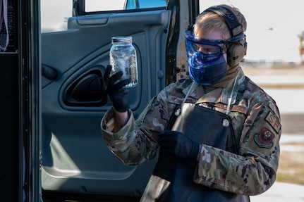 man holds jar