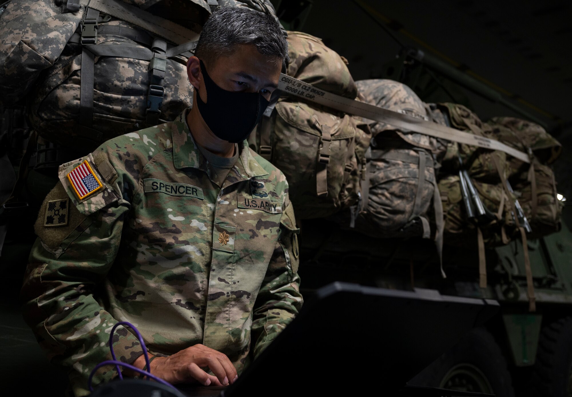 A U.S. Soldier with America’s I Corps sets up and tests a new, early entry command post concept aboard a C-17 Globemaster III while flying in the U.S. Indo-Pacific Command area of responsibility during Exercise Rainier War 21B Nov. 9, 2021. I Corps deployment and redeployment efforts from Andersen Air Force Base, Guam, included ensuring uninterrupted communication capabilities, even while in flight, aboard a C-17 Globemaster III. Rainier War 21B exercised and evaluated the 62nd Airlift Wing’s ability to employ the force and their ability to perform during wartime and contingency taskings in a high-intensity, wartime contested, degraded and operationally limited environment while supporting the contingency operations against a near-peer adversary in the U.S. Indo-Pacific Command area of responsibility. (U.S. Air Force photo by Staff Sgt. Rachel Williams)