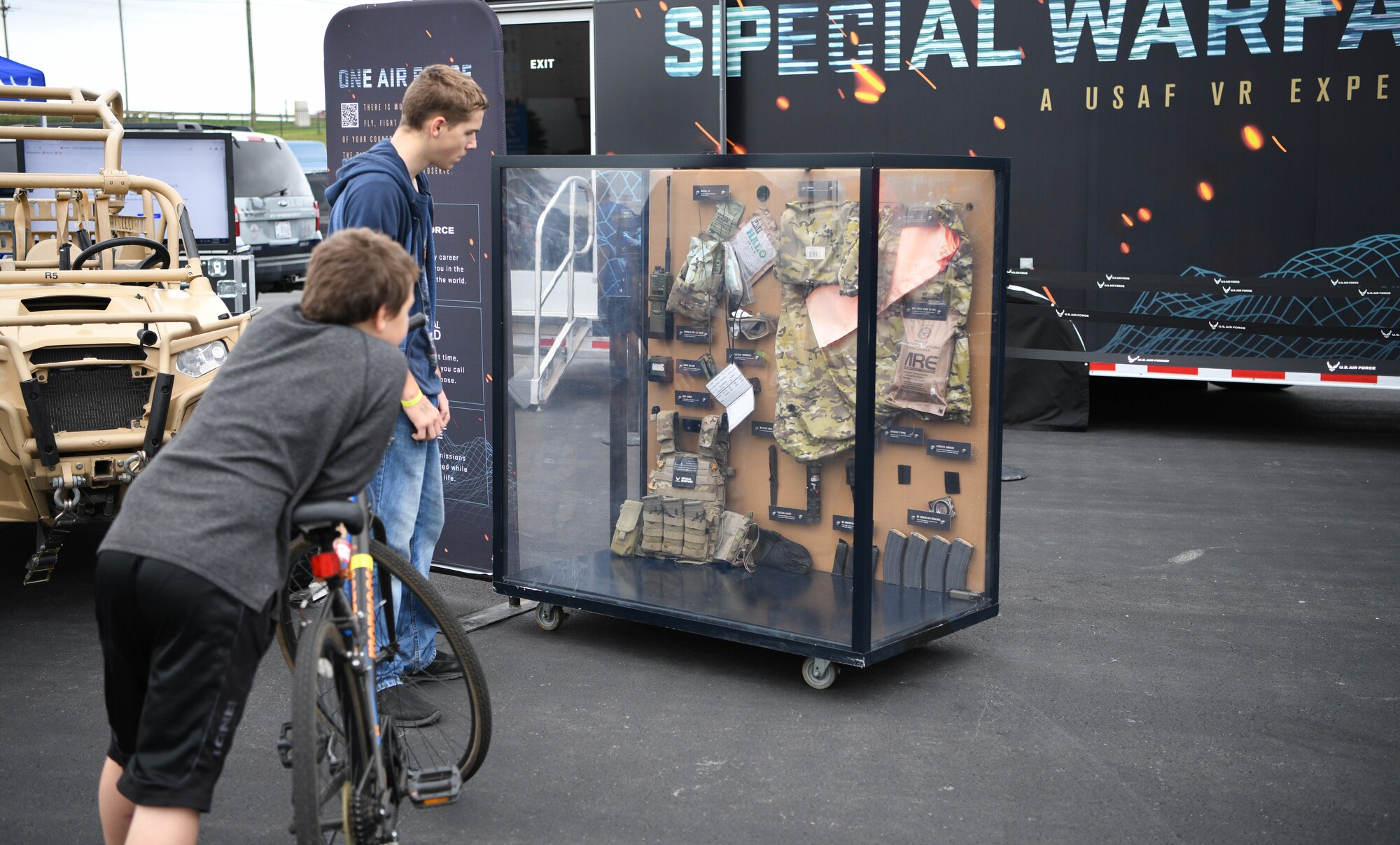 Passersby examine a display case outside of Charlotte Motor Speedway in Conway, North Carolina, which featured tactical equipment similar to what Special Warfare Airmen might use.