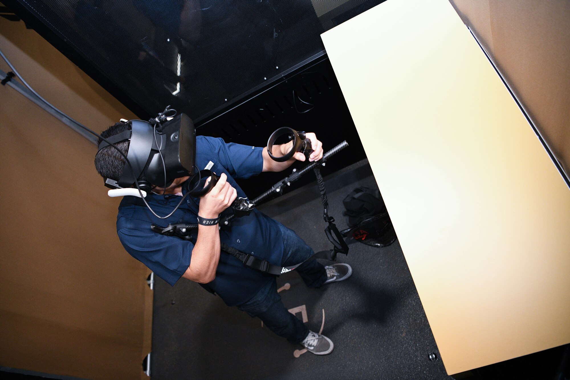 A guest with virtual reality goggles and a replicated gun gets a four-dimensional Air Force Special Warfare experience at the Fanzone on Oct. 9, 2021, outside of Charlotte Motor Speedway in Conway, North Carolina.