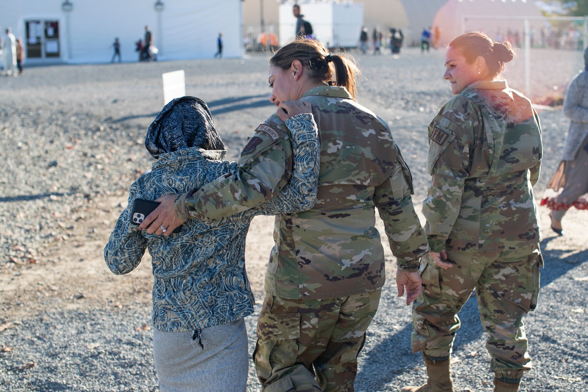 U.S. Air Force Col. Bernadette Maldonado and Lt. Col. April Doolittle, New Jersey Air National Guardsmen assigned to the 108th Wing, walk with an Afghan girl in Liberty Village on Joint Base McGuire-Dix-Lakehurst, N.J., Nov. 8, 2021. The Department of Defense, through U.S. Northern Command, and in support of the Department of Homeland Security, is providing transportation, temporary housing, medical screening, and general support for at least 50,000 Afghan evacuees at suitable facilities, in permanent or temporary structures, as quickly as possible. This initiative provides Afghan personnel essential support at secure locations outside Afghanistan.