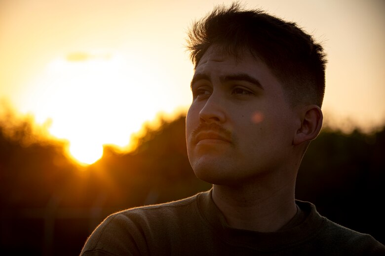 U.S. Marine Corps Lance Cpl. Hunter Barber, a combat graphics specialist with Communication Strategy and Operations, Combat Logistics Regiment 37, 3rd Marine Logistics Group, poses for a photo on Camp Kinser, Okinawa, Japan, Nov. 17, 2021. Barber is a White Mountain Apache tribal member who grew up on the Fort Apache reservation in Arizona. "Resilient and Enduring: We Are Native People" is the November 2021 theme to honor the past and present Native American Marines who continue to pave the way for future generations. (U.S. Marine Corps photo by Cpl. Karis Mattingly)