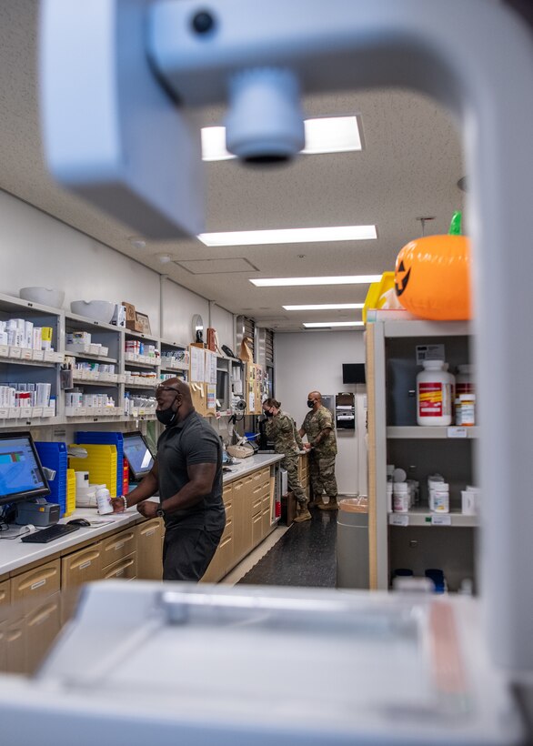 Pharmacists work in a pharmacy at Kadena Air Base, Japan