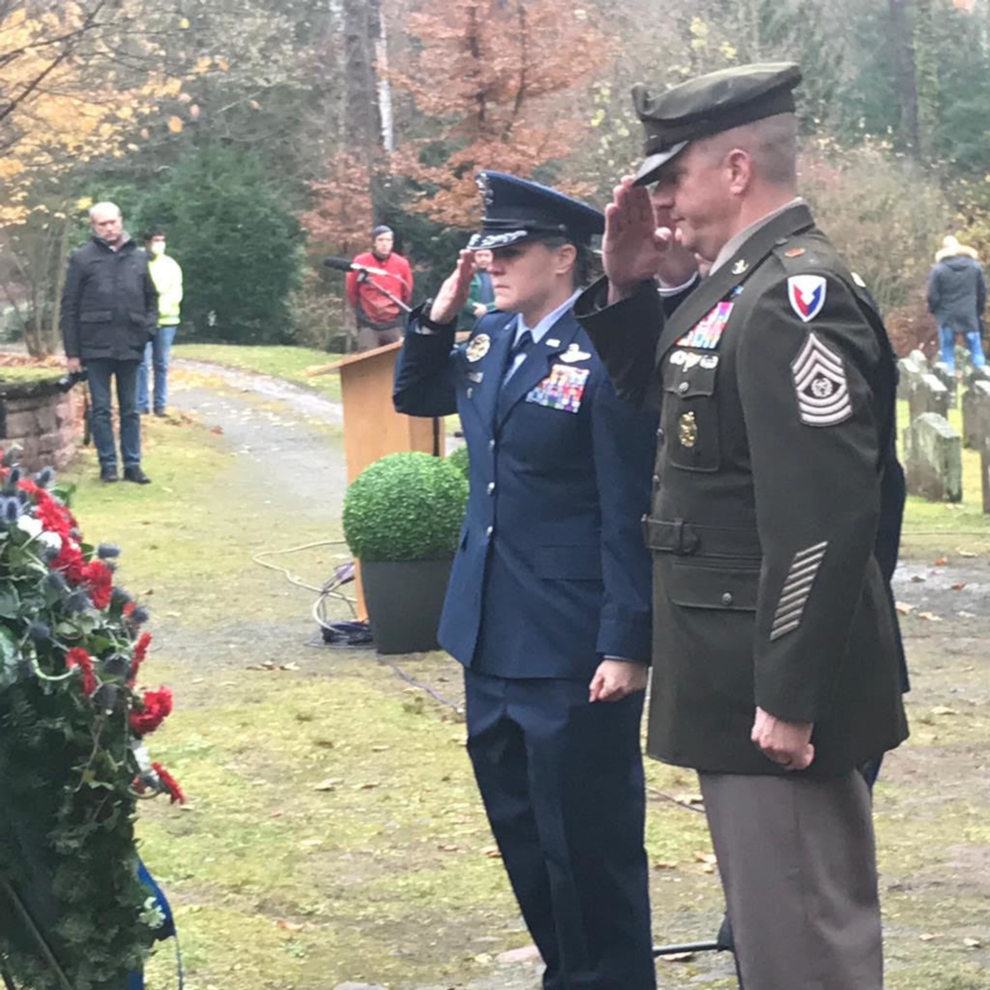 Two military members saluting.