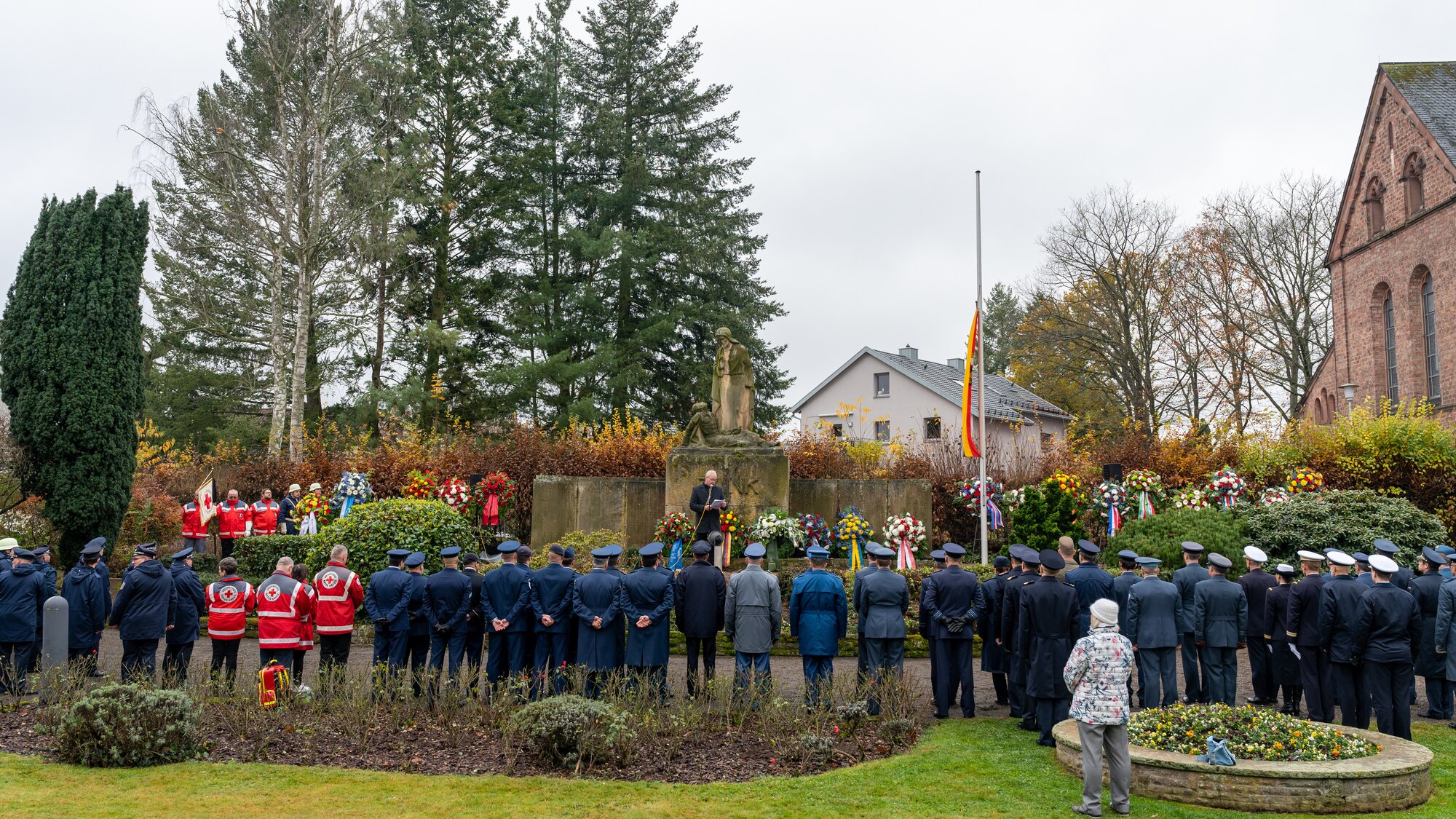 A crowd standing around a monument.