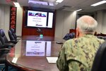 211119-N-UA460-0001 SEMBAWANG NAVAL BASE, Singapore (Nov. 19, 2021) Rear Adm. Philip Sobeck, commander, Logistics Group Western Pacific and Task Force 73, observes virtual closing ceremony of Cooperation Afloat and Readiness at Sea Training (CARAT) Brunei 2021. In its 27th year, the CARAT series is comprised of multinational exercises, designed to enhance U.S. and partner navies’ abilities to operate together in response to traditional and non-traditional maritime security challenges in the Indo-Pacific region. (U.S. Navy photo by Mass Communication Specialist 1st Class Greg Johnson)