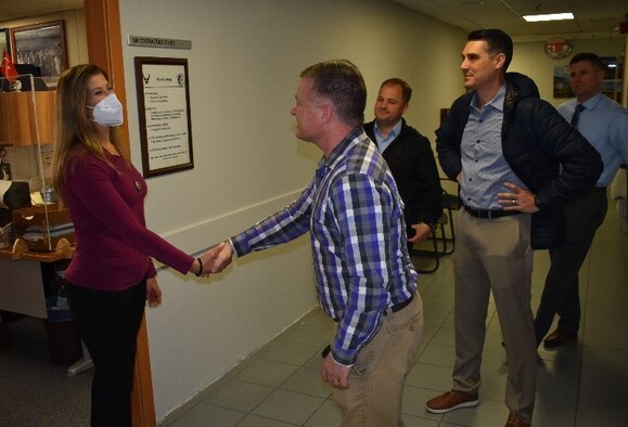 man shaking woman's hand